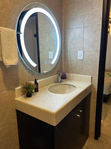a bathroom with a sink and a mirror at blue angel 1 aunos pasos de la 5 av in Playa del Carmen