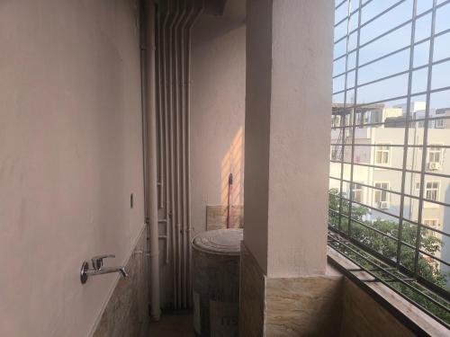 a hallway in a building with a large window at Orraica Stays Aurum Vajra in Haidar Sāhibgūda