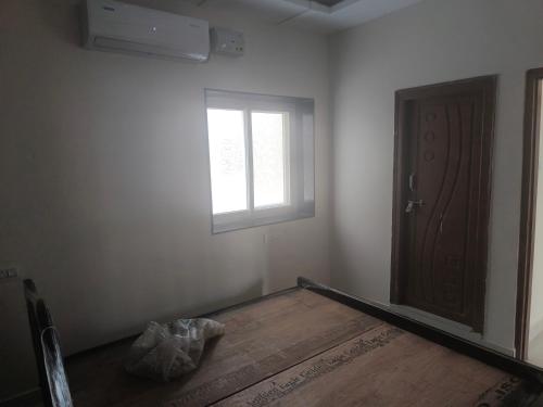 an empty room with a door and a window at Orraica Stays Aurum Vajra in Haidar Sāhibgūda