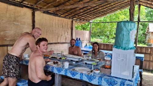 a group of people sitting around a table at Raja Ampat Jousuba Homestay in Minyaifuin