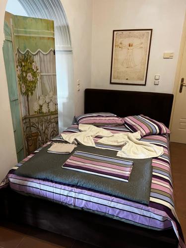 a bed with towels on it in a room at Silver Apartment with Swimming Pool in Rafina
