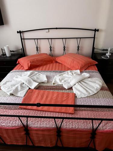 a bed with two towels on top of it at Silver Apartment with Swimming Pool in Rafina