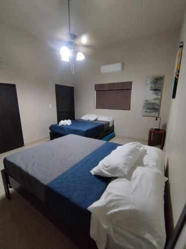 a hotel room with two beds and a chalkboard at DGMLoftsTEC comodo zona sur MTY in Monterrey