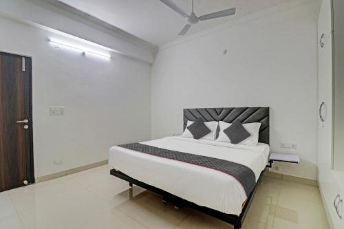 une chambre avec un grand lit dans une pièce dans l'établissement Super TOWNHOUSE JAHNAVI GROUP BESIDES NEXUS MALL, à Hyderabad