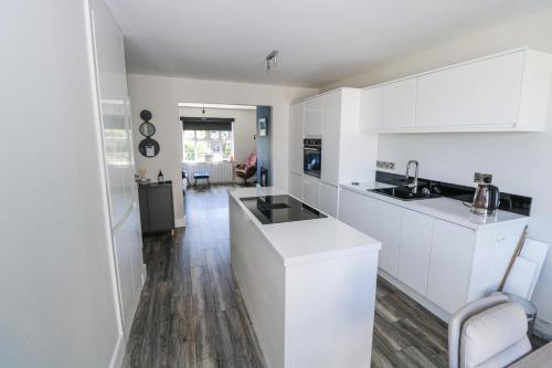 a kitchen with white cabinets and a counter top at Waterview House in Newport