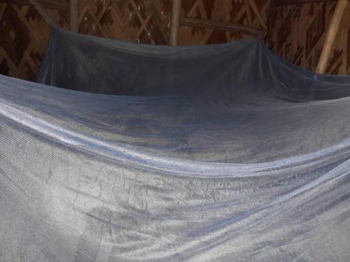 a net on the inside of a hammock at J60 Beach Guest House in Asini