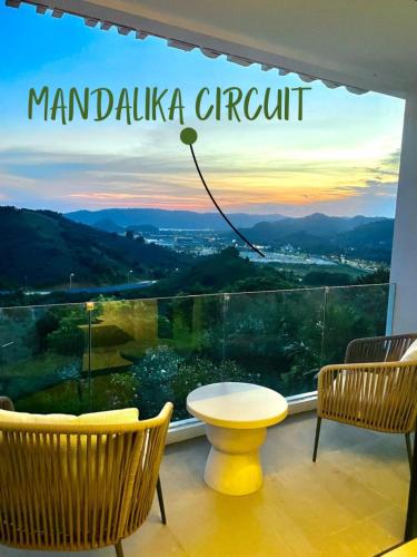 a room with a window with a table and chairs at Truntum Boutique Mandalika in Kuta Lombok