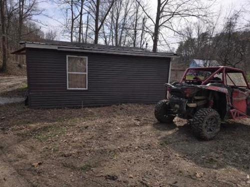 a jeep parked in front of a small house at The Happy Place in Glouster