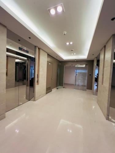 an empty lobby of a building with white floors at Sea Residences Mall of Asia Viann in Manila