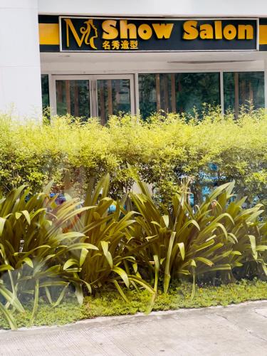 a group of plants in front of a show salon at Sea Residences Mall of Asia Viann in Manila