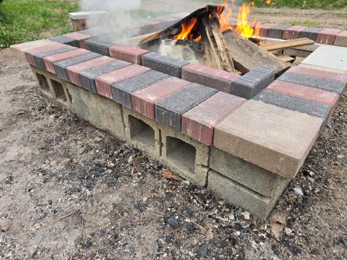 a fire pit with bricks on it in the dirt at The Happy Place in Glouster