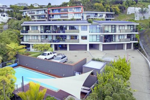 an aerial view of a large house with a pool at Kaiteriteri Luxury Apartment in Kaiteriteri