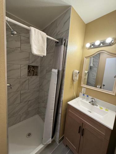 a bathroom with a shower and a sink at Tahoe Sands Inn in South Lake Tahoe