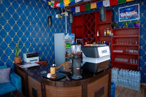 a bar with a blender on top of a counter at Misha's Peaceful Retreat Near Pokhara, Free Yoga, cafe, Nature and Comfort in Pokhara