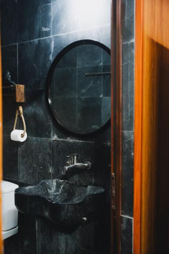 a black bathroom with a sink and a mirror at Amazing Ninh Binh Garden in Xuân Sơn