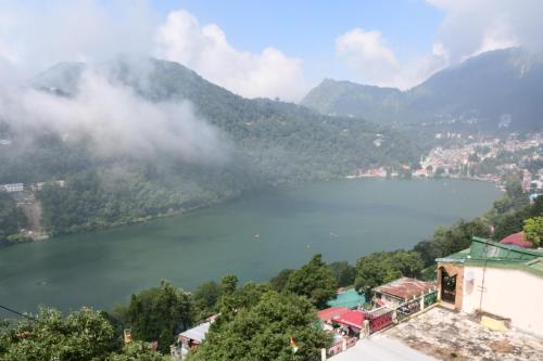 a view of a lake with mountains in the background at Nainital Stays in Nainital