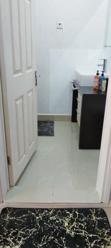 a room with a white door and a white tile floor at Gold of Grand Baie in Midlands Station