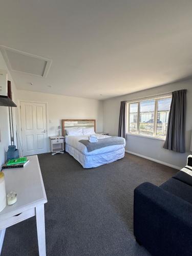 a hotel room with a bed and a couch at Self-Contained Wanaka GuestHouse in Wanaka