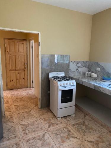 a kitchen with a stove and a counter top at Marshan villa in Montego Bay