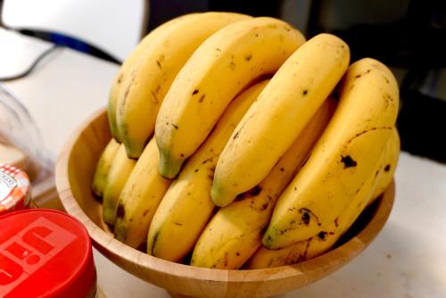 a bunch of bananas in a bowl on a table at Kuha Phuket Old Town in Phuket Town