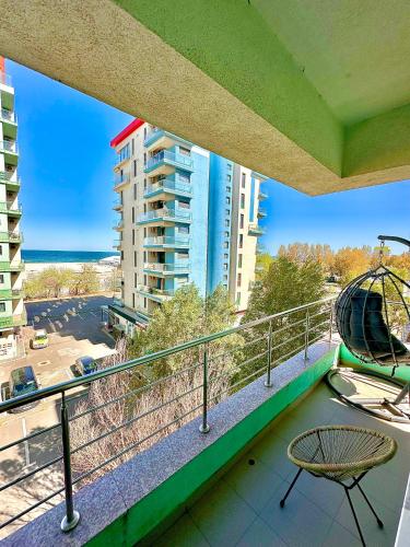 a balcony with a view of the beach and buildings at Summerland Seaview Apartments in Mamaia
