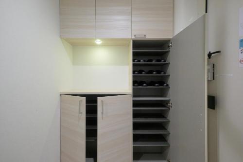 a walk in wine cellar with a closet with black shelves at Z LAND Enoshima in Fujisawa