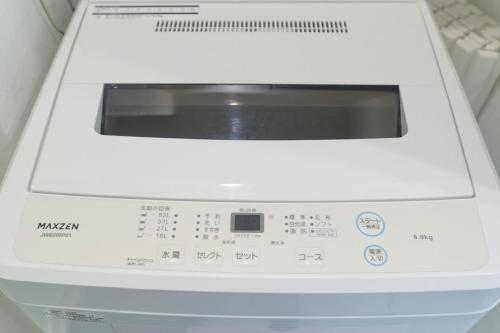 a white washing machine sitting on a shelf at Z LAND Enoshima in Fujisawa