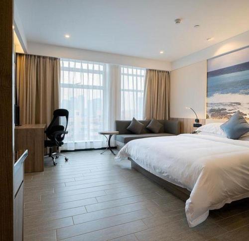 a bedroom with a large bed and a couch at hailihotel in Dongguan