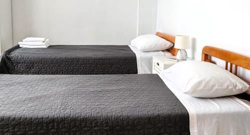 two beds in a hotel room with two beds at Konstantina's cottage Ideal BaseforBalos & Elafonisi in Kissamos
