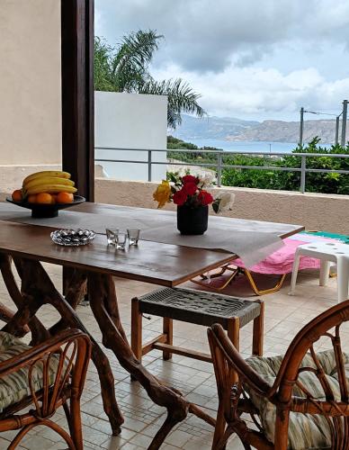 a wooden table with bananas on top of a balcony at Konstantina's cottage Ideal BaseforBalos & Elafonisi in Kissamos