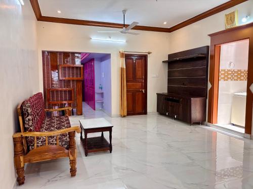 a living room with a couch and a piano at Sree Paradise Homestay in Tiruvannāmalai
