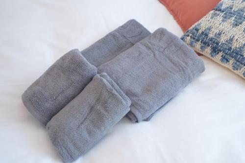 a pair of gray socks on a bed with pillows at Z LAND Enoshima in Fujisawa