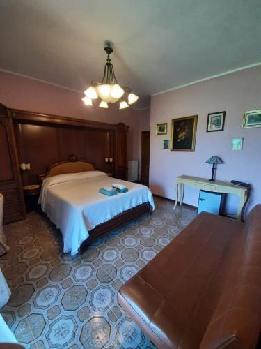 a bedroom with a large bed and a table at villamuna in Ferentillo