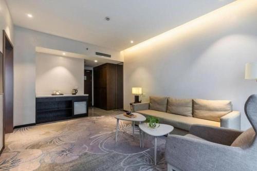 a living room with a couch and a table at International Conference Hotel Nanjing in Nanjing