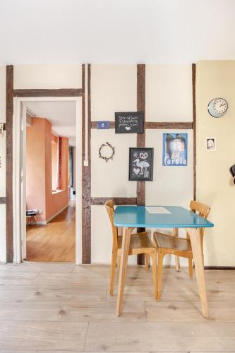 une salle à manger avec une table et des chaises bleues dans l'établissement Ecologement cosy au centre de Strasbourg, à Strasbourg