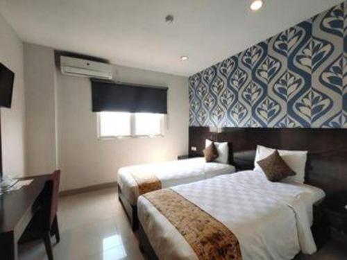 Кровать или кровати в номере Jelita Bandara Hotel Airport