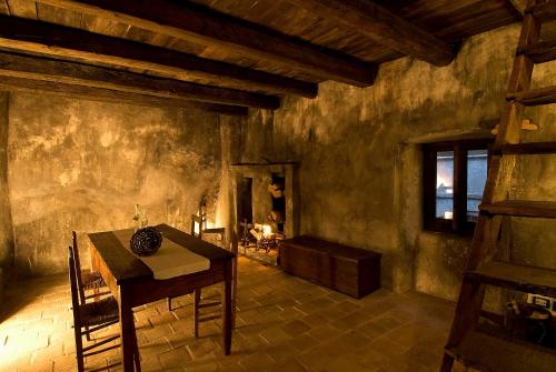 a room with a table and a chair in it at Sextantio Albergo Diffuso in Santo Stefano di Sessanio
