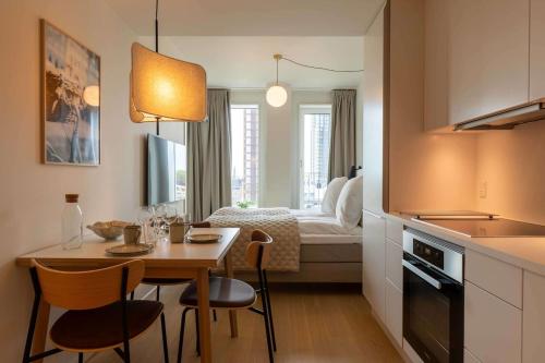 a small kitchen and dining room with a table and chairs at Cozy 9th Floor Apartment in Vesterbro in Copenhagen