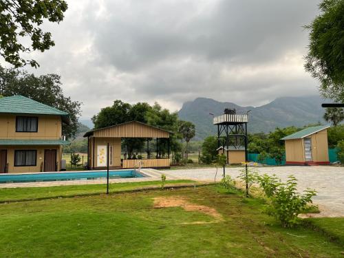 a resort with a swimming pool and a gazebo at Kava Eco camp and Caravan park, Manthuruthy,Malampuzha- Anakkal Road, Palakkad Dist in Palakkad