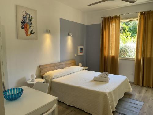 a bedroom with two beds and a window at inKanto Room in Cefalù