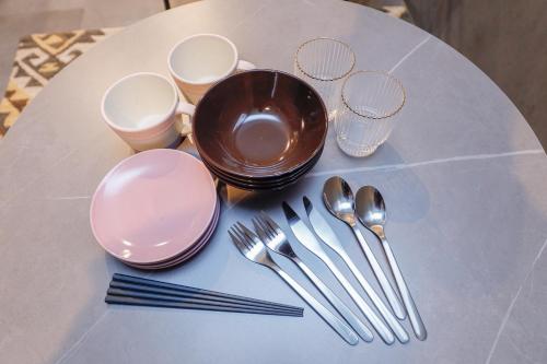 a white table with silverware on top of a table at Flat K Plum Umegaoka in Tokyo