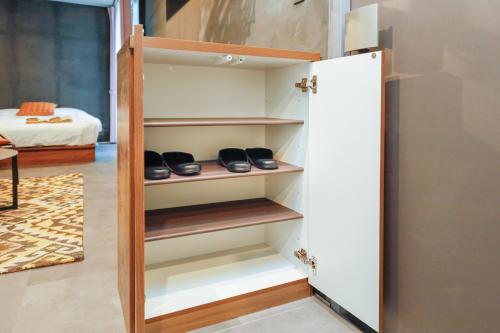 a cupboard with shoes in it in a room at Flat K Plum Umegaoka in Tokyo