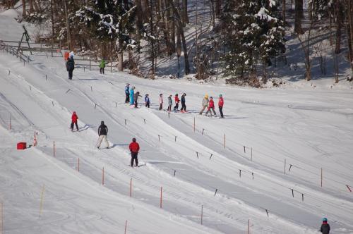 a group of people skiing down a snow covered slope at Landhotel Maiergschwendt inkl Chiemgaukarte in Ruhpolding