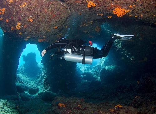 a person with a camera in the water at Popi Studios in Arkasa