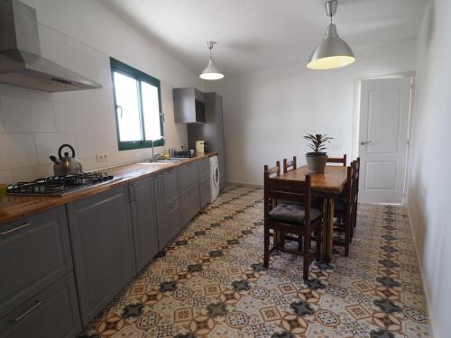 a kitchen with a table and chairs and a dining room at Max house in Teguise