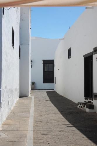 a hallway of a white building with a doorway at Max house in Teguise