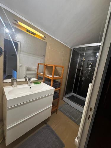 a bathroom with a sink and a large window at CHALET Tout Confort Proche d AX 3 Domaines in Vèbre