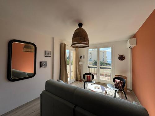 un salon avec un canapé et un miroir dans l'établissement Armonia - Appartement en centre-ville, à Calvi
