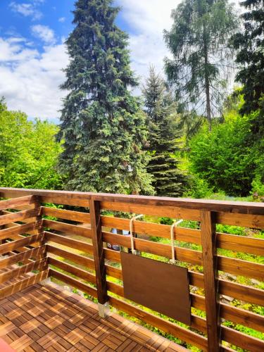 a wooden privacy fence with a bench on a deck at Bed and Breakfast Tvrz in Velká Bukovina