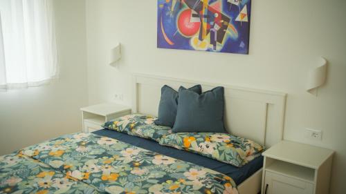 a bedroom with a bed with a colorful comforter and pillows at Texlhof - Stella Alpina in Parcines